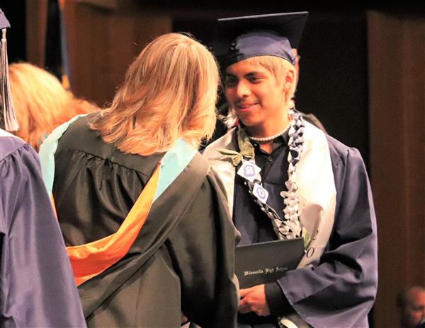 Wilsonville High student Jair Gamez-Carrasco walks across the graduation stage.